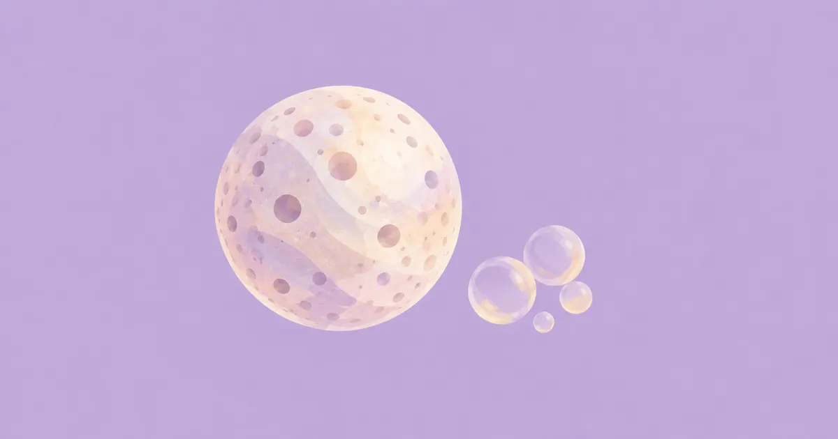 One porous pearl bead beside a cluster of tiny translucent bubbles